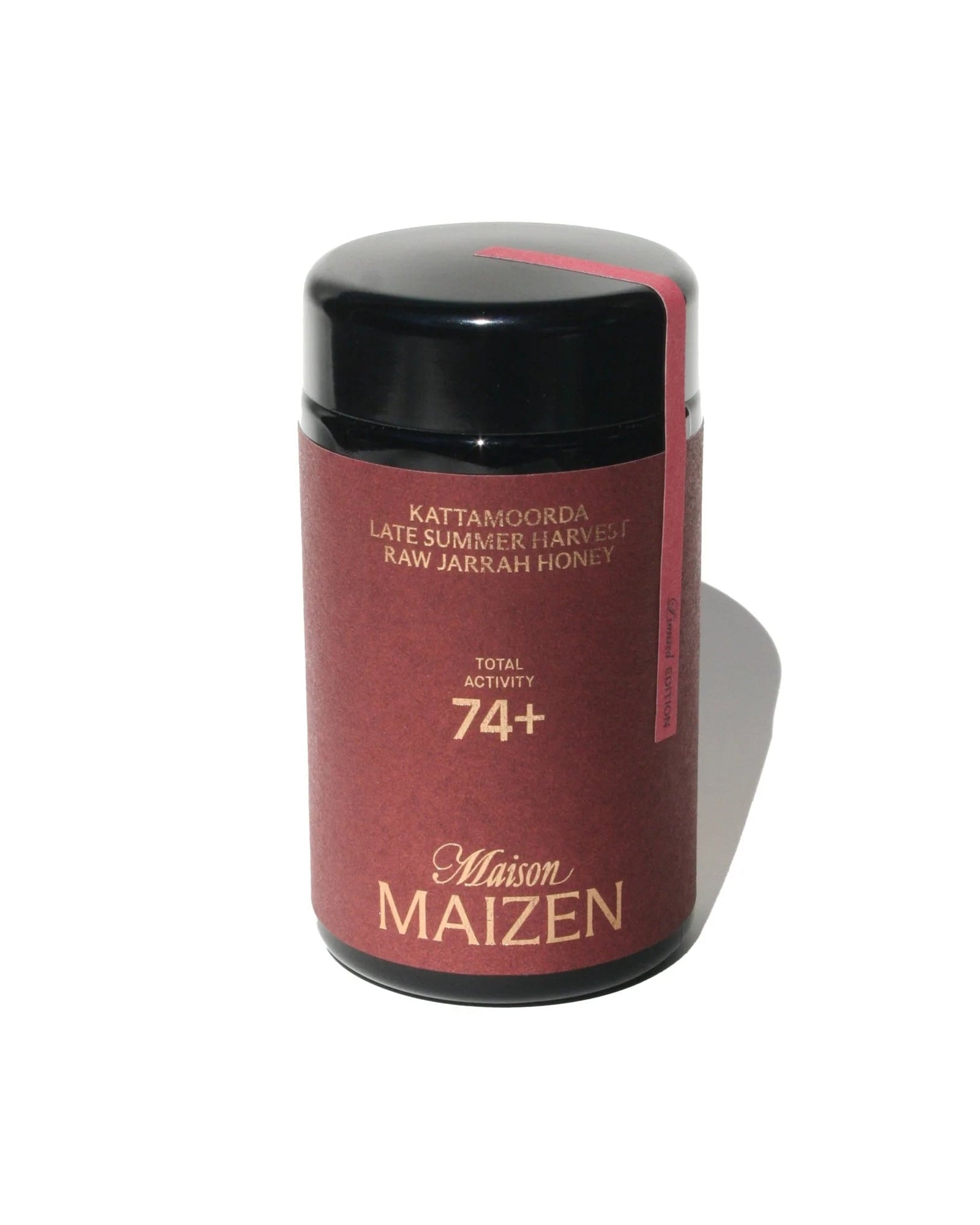 Maison Maizen honey container with black lid on a white background